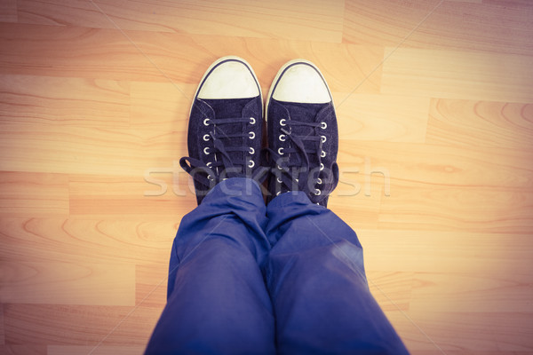 Low section of man standing on hardwood floor Stock photo © wavebreak_media