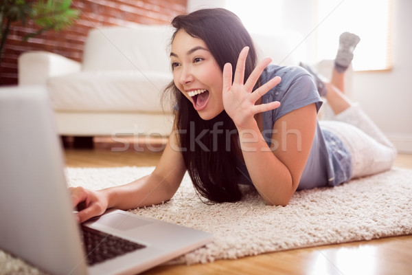 Stock photo: Asian woman using laptop on floor