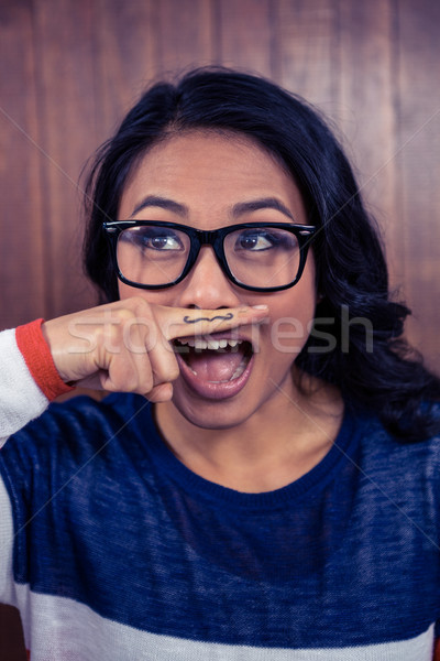 Asian femme moustache doigt bois mur [[stock_photo]] © wavebreak_media