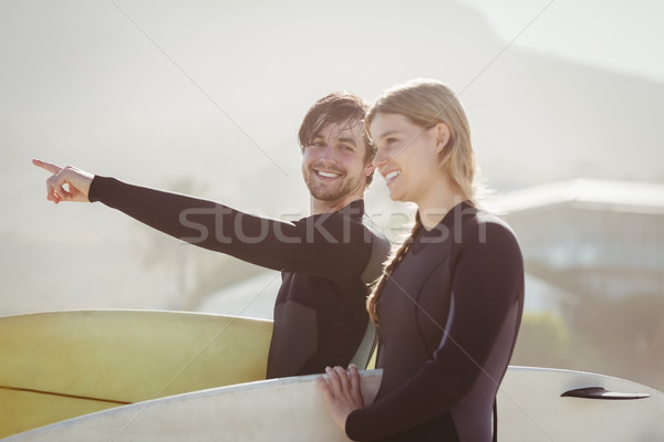 Casal prancha de surfe em pé praia mulher Foto stock © wavebreak_media