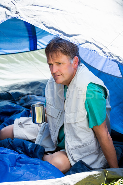 senior man holding a cup of coffee and is sitting in his tent Stock photo © wavebreak_media