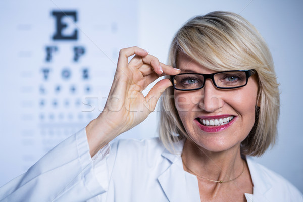 Smiling female optometrist wearing spectacles Stock photo © wavebreak_media