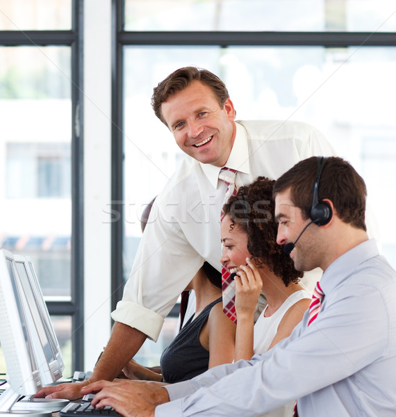 Mature manager in a call center smiling at the camera Stock photo © wavebreak_media