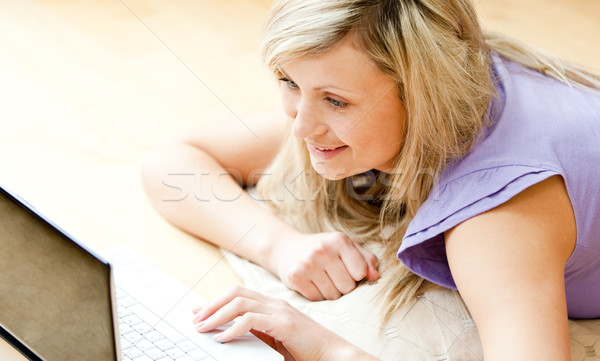 Bright woman using a laptop in the living-room Stock photo © wavebreak_media