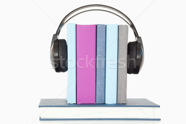 Headphones around books against a white background Stock photo © wavebreak_media
