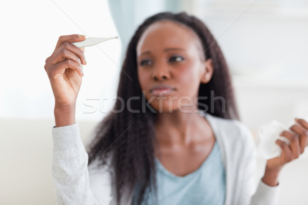 Close up of young woman measuring temperatur Stock photo © wavebreak_media