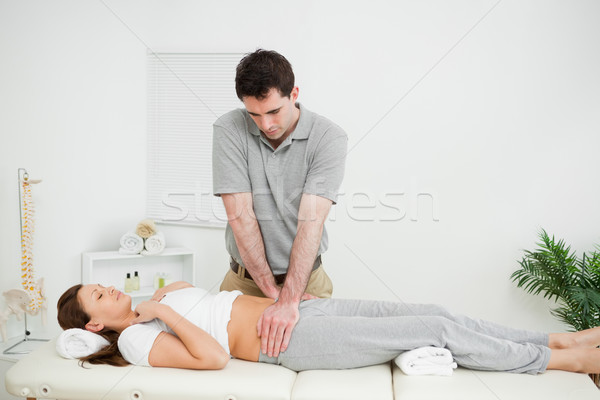 Peaceful woman being touched by an osteopath in his medical room Stock photo © wavebreak_media