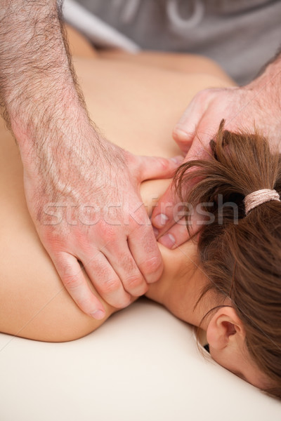 Shoulders of woman being squeezed while lying on a table in a room Stock photo © wavebreak_media