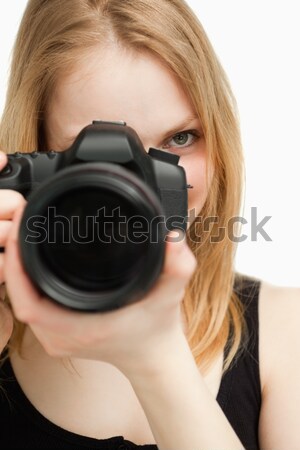 Close up of a woman holding a camera against white background Stock photo © wavebreak_media