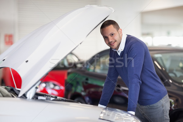 Man leaning over a car in a dealership Stock photo © wavebreak_media