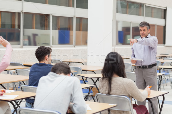 Teacher pointing at student asking question in classroom in college Stock photo © wavebreak_media