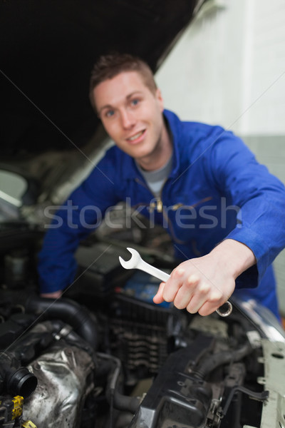 Mechanic with spanner repairing car Stock photo © wavebreak_media