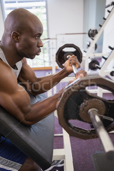 Determined muscular man lifting barbell in gym Stock photo © wavebreak_media