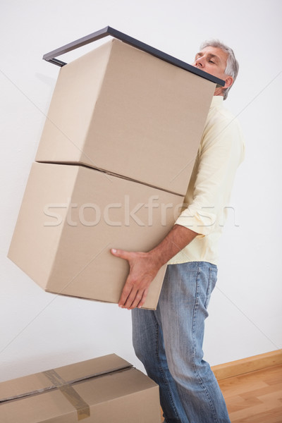 Homem equilíbrio pesado cartão caixas casa Foto stock © wavebreak_media