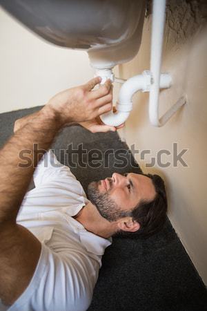 Plumber fixing the sink in a bathroom Stock photo © wavebreak_media