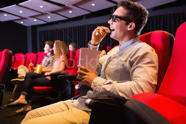 Stock photo: Young friends watching a 3d film