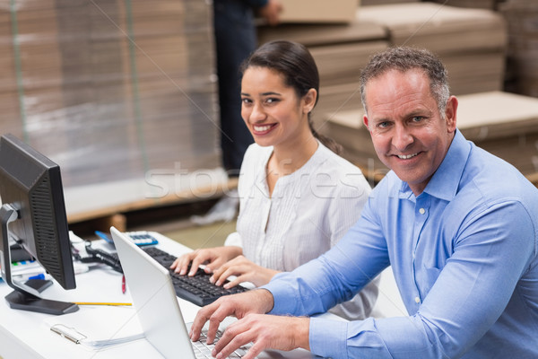 Warehouse managers working with laptop at desk Stock photo © wavebreak_media