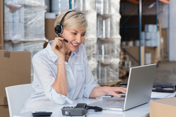 Smiling warehouse manager using laptop Stock photo © wavebreak_media