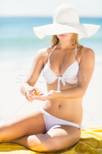 Pretty blonde woman putting sun tan lotion on her hand Stock photo © wavebreak_media