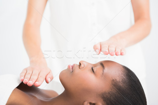 Pretty woman enjoying a reiki technique Stock photo © wavebreak_media