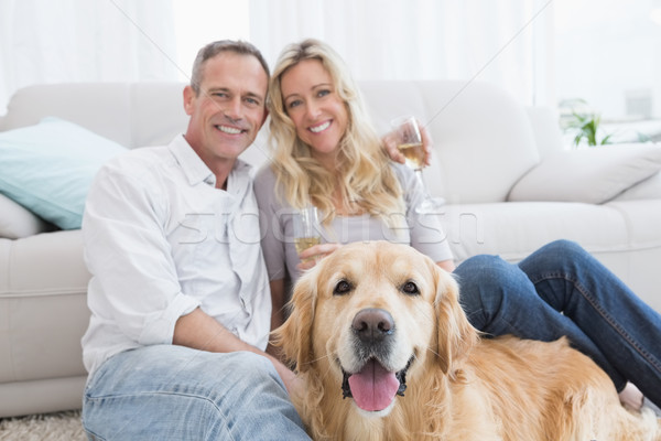 Couple drinking champagne with their dog in front of them Stock photo © wavebreak_media