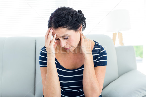 Unhappy woman sitting on the couch Stock photo © wavebreak_media