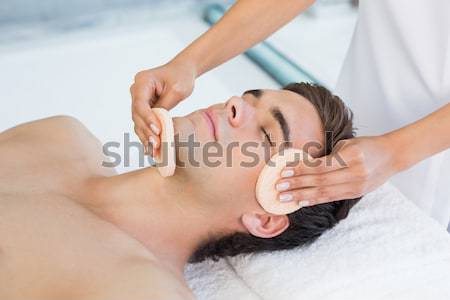 Stock photo: Attractive woman receiving facial massage at spa center