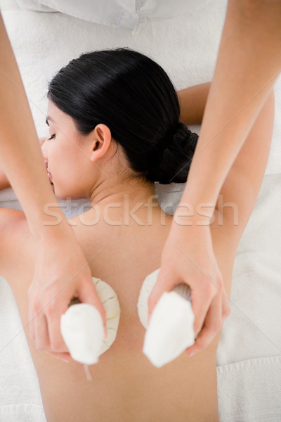 Pretty woman enjoying a herbal compress massage Stock photo © wavebreak_media