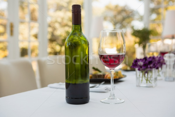 Wineglass and bottle on table in restaurant Stock photo © wavebreak_media