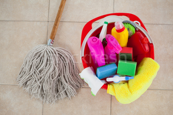 Stock photo: Bucket with cleaning supplies and mop on tile floor