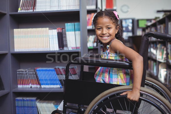 Sorridere ragazza sedia a rotelle biblioteca ritratto seduta Foto d'archivio © wavebreak_media