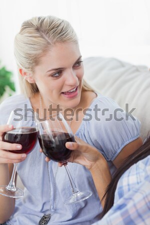 Beautiful woman holding glass of red wine Stock photo © wavebreak_media