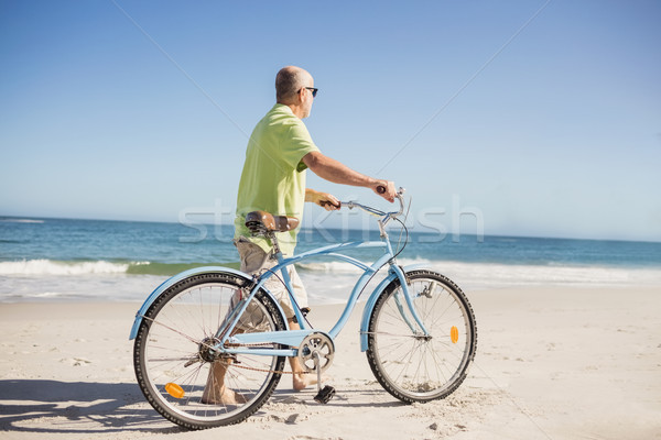 Stock photo: Smiling senior man with bike