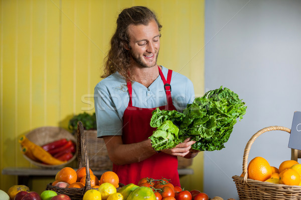 Smiling staff looking at leafy vegetables at counter Stock photo © wavebreak_media