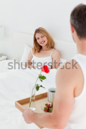 Stock photo: Affectionate husband giving a present to his wife