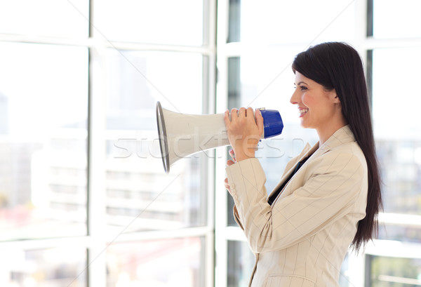 Stock photo: Businesswoman shouting through megaphone