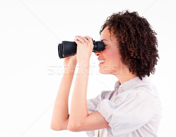 Smiling brunette businesswoman looking through binoculars  Stock photo © wavebreak_media
