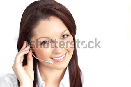 Charming young businesswoman wearing earpiece against a white background Stock photo © wavebreak_media