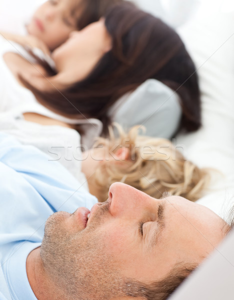 Serene family sleeping together in the morning in the parents's bed Stock photo © wavebreak_media