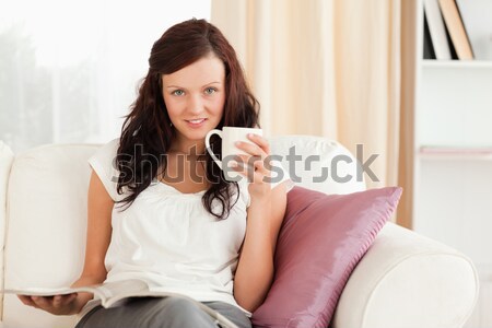 Stock photo: Happy woman looking a pregnancy test while her boyfriend sleeping on the background