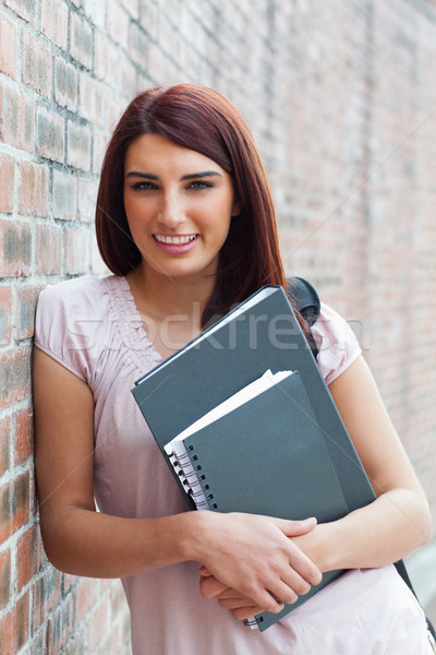 Portrait of a happy student holding her binders outside the building Stock photo © wavebreak_media