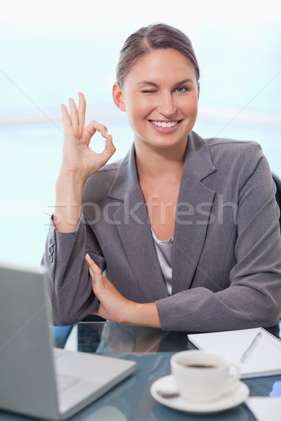 Portrait of a young businesswoman signing that everything is okay with a knowing smile Stock photo © wavebreak_media