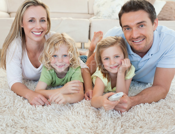 Famille regarder tv ensemble étage fille [[stock_photo]] © wavebreak_media