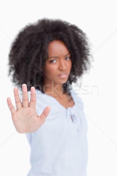 Young angry woman making the hand stop sign against a white background Stock photo © wavebreak_media