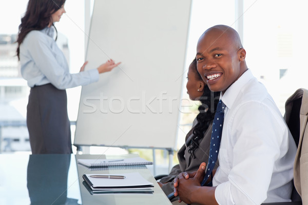 Young smiling executive sitting with his hands crossed and listening to a presentation Stock photo © wavebreak_media