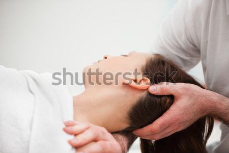 Doctor manipulating the neck of a woman in a room Stock photo © wavebreak_media