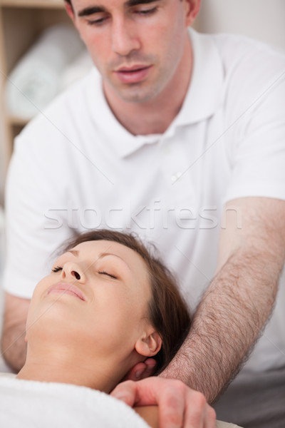 Physiotherapist manipulating the neck of his patient in a room Stock photo © wavebreak_media