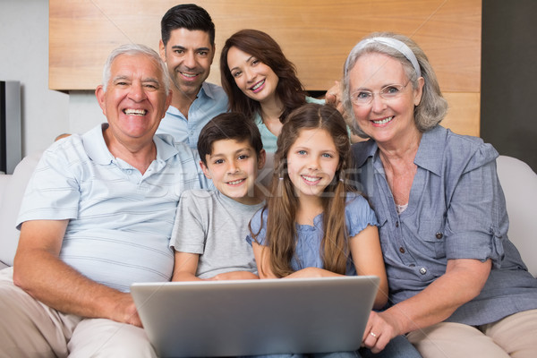 Extended family using laptop on sofa in living room Stock photo © wavebreak_media