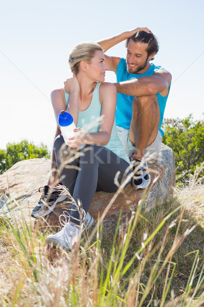 Stock photo: Fit couple taking a break at summit smiling at each other