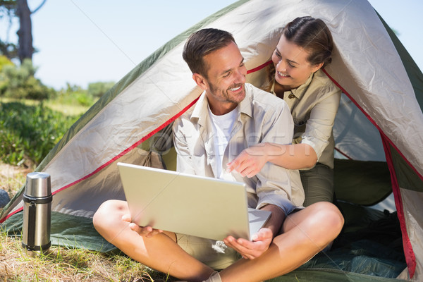 Couple regarder portable à l'extérieur tente [[stock_photo]] © wavebreak_media